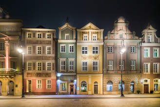 a row of buildings lit up at night