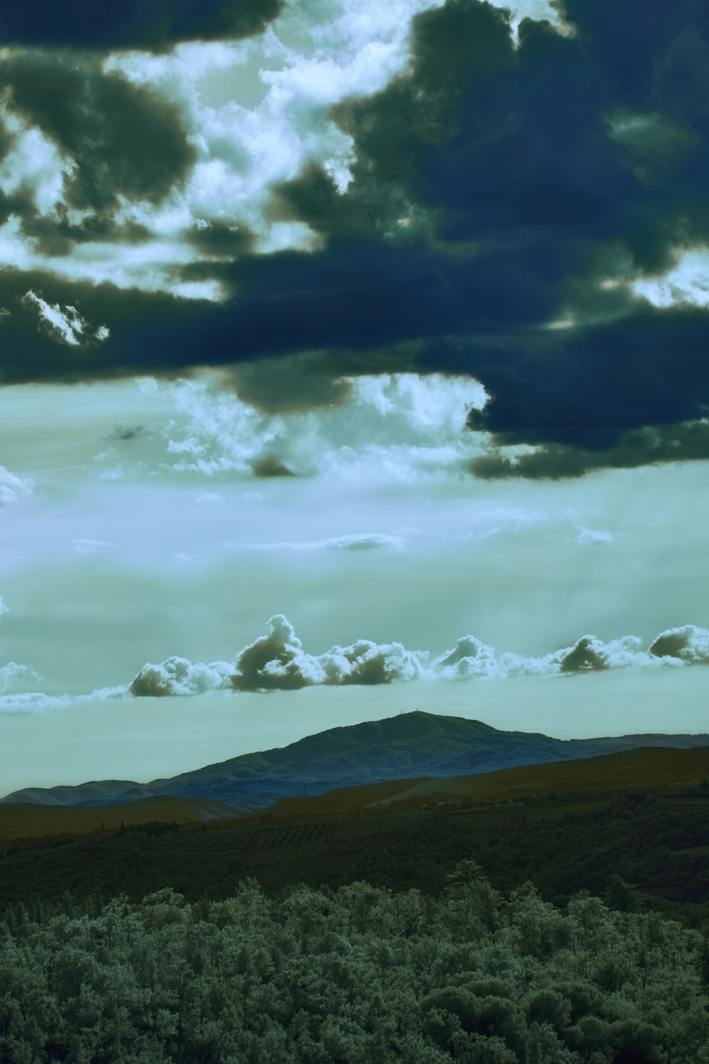 a view of a mountain range under a cloudy sky