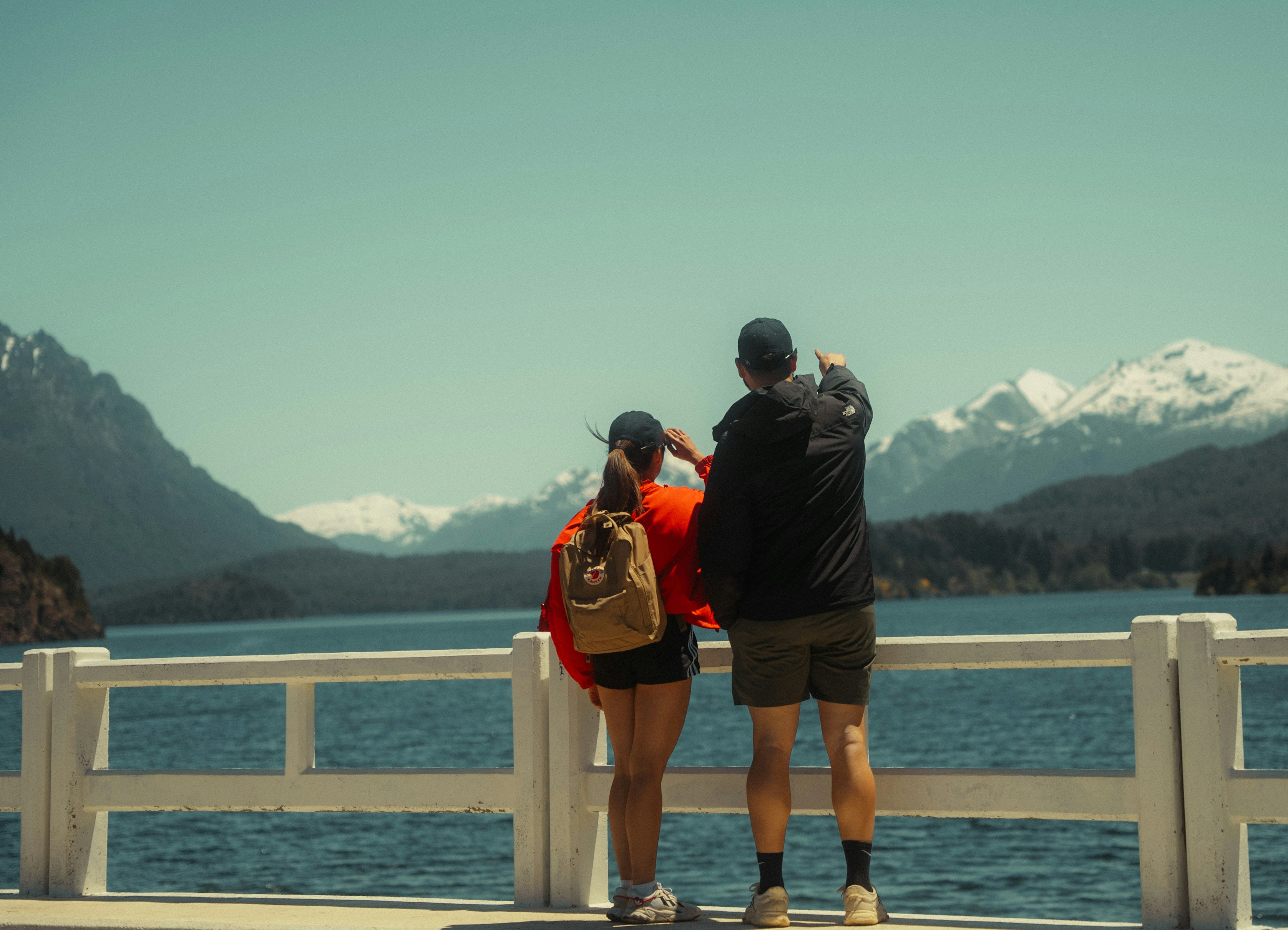 a man and a woman taking a picture of the mountains