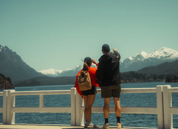 Couple overlooking a lake and mountains while traveling together.