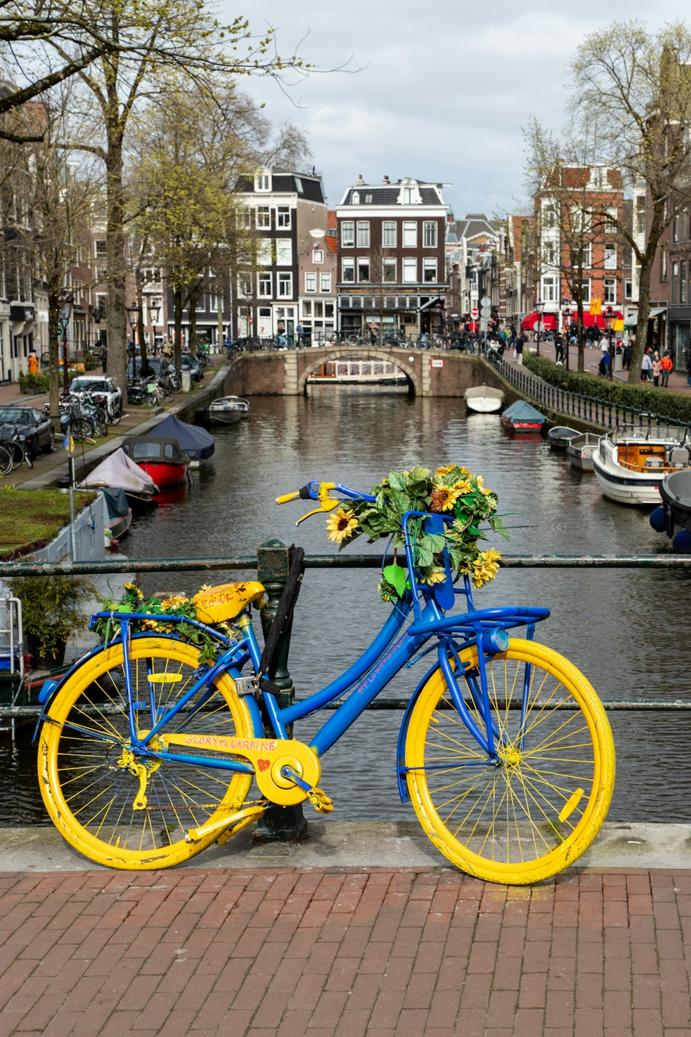 a blue and yellow bike parked next to a river