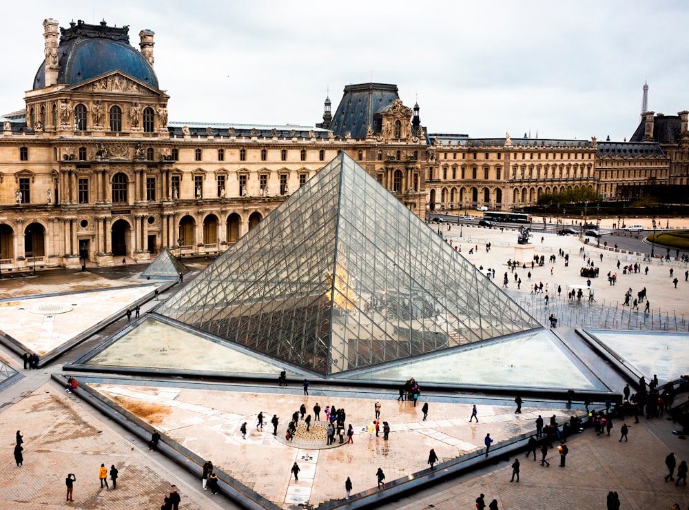 a large glass pyramid in front of a building