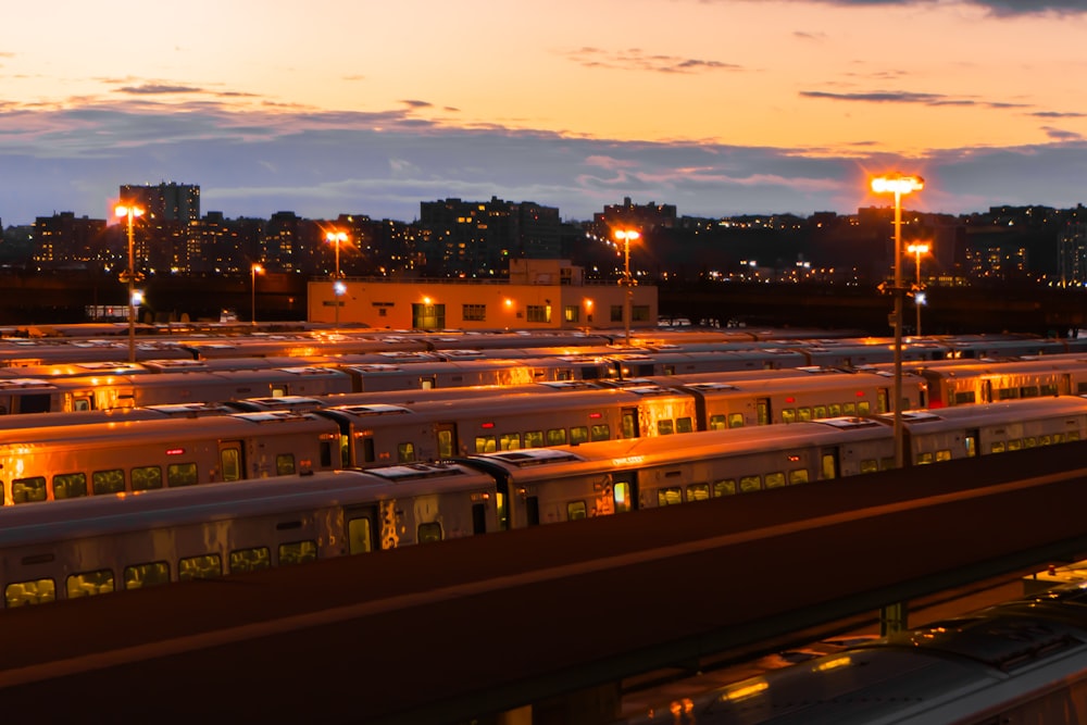 a train station with many trains parked at night