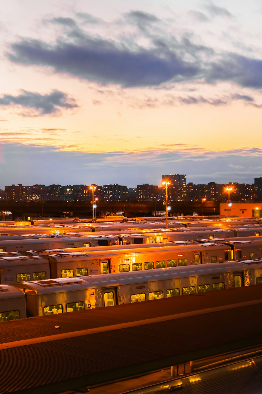 a parking lot full of buses at dusk