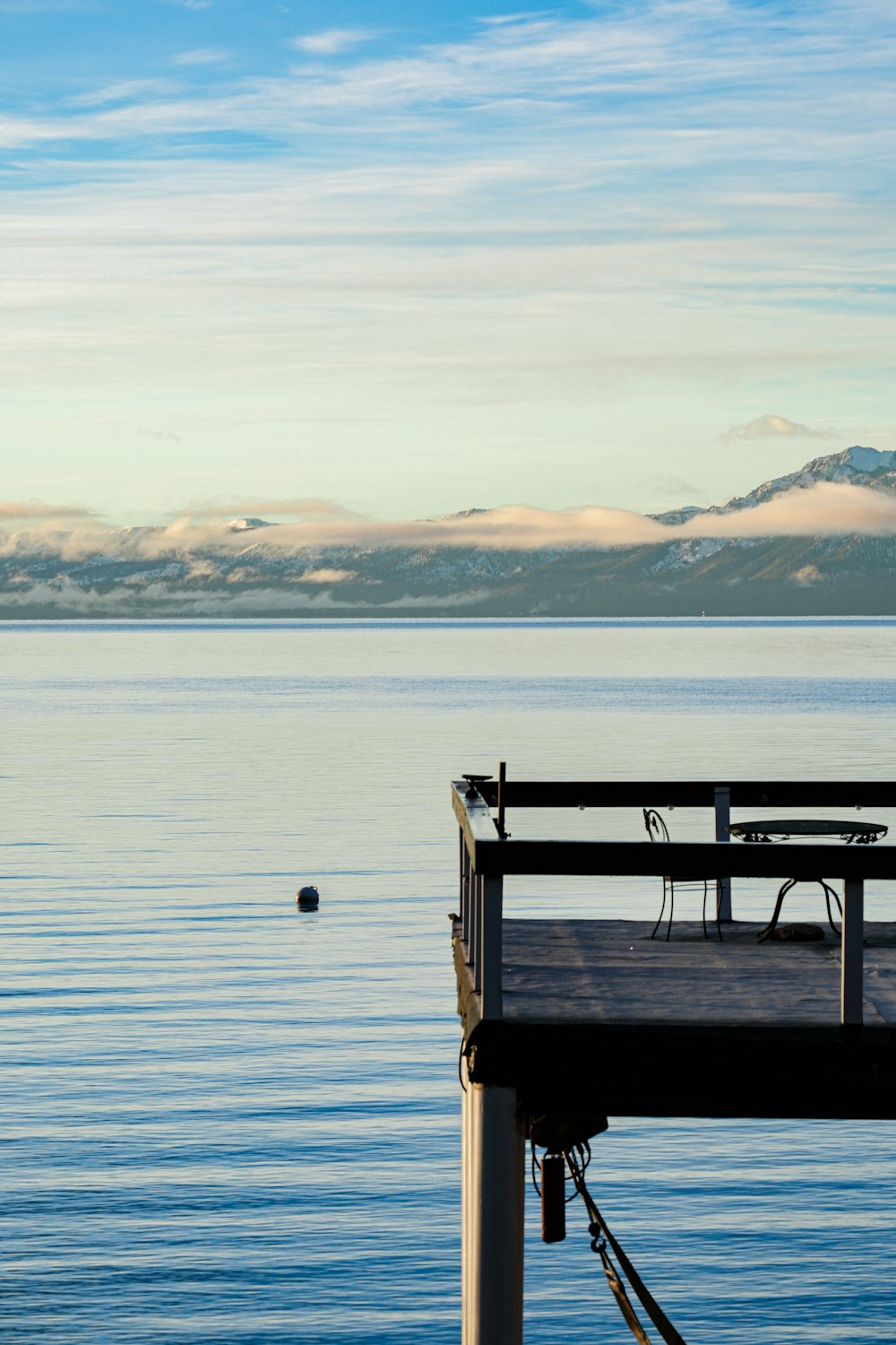 a dock with a chair and a table on it