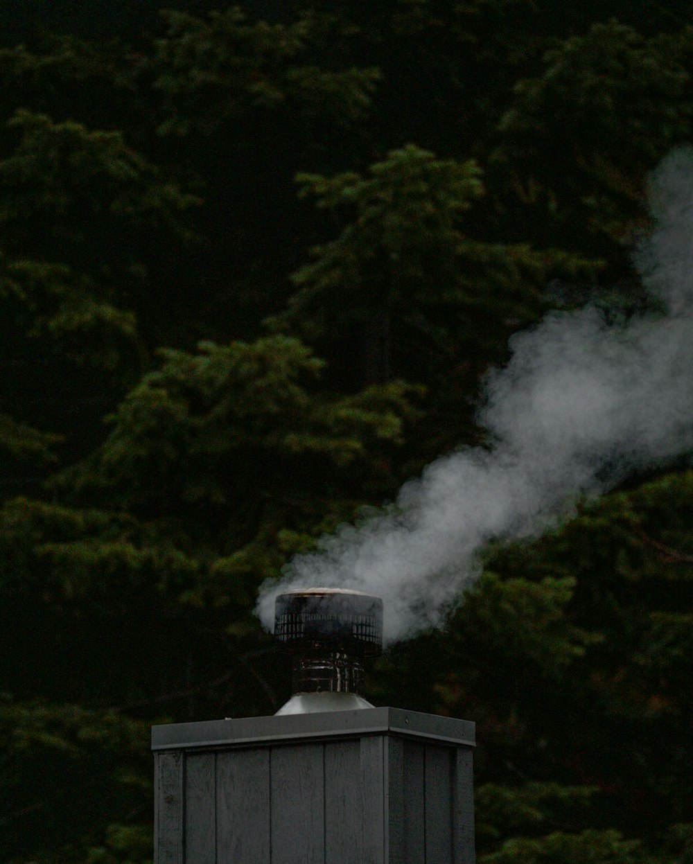 smoke coming out of a chimney on top of a building