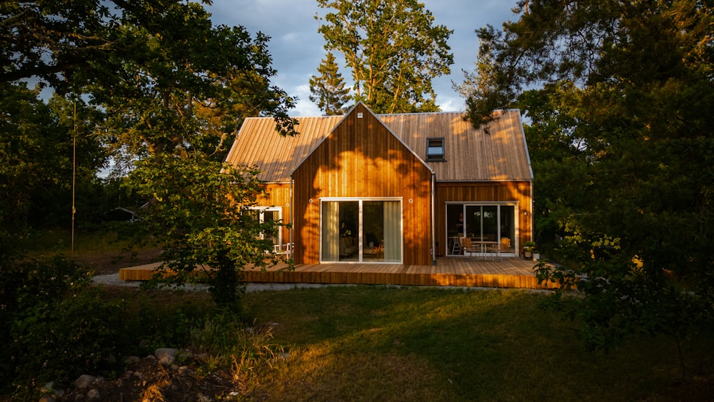 a small wooden house surrounded by trees on a sunny day