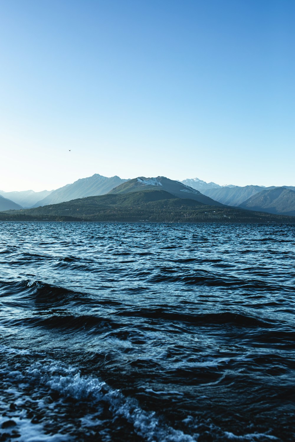 a body of water with mountains in the background