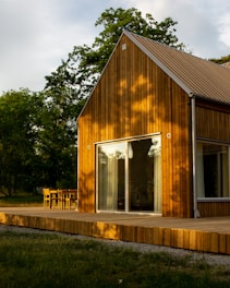 a wooden house with a deck and a patio