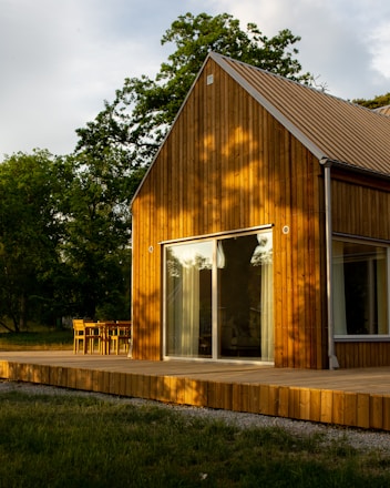 a wooden house with a deck and a patio