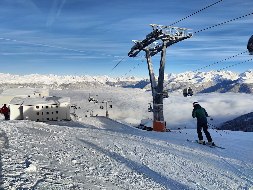 a man riding skis down a snow covered slope