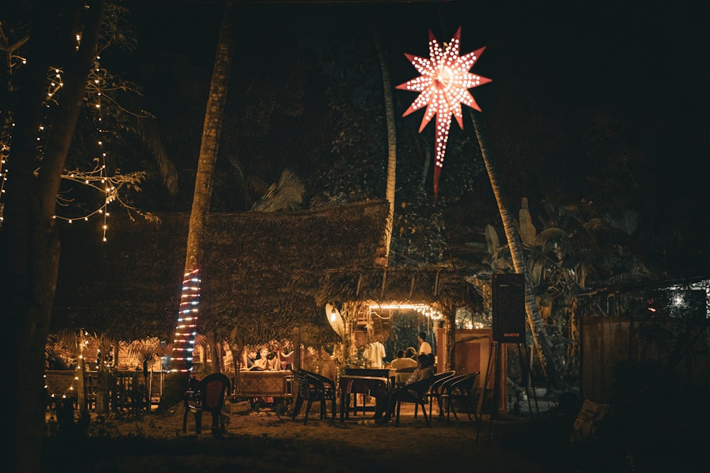 a christmas star is lit up in the night sky