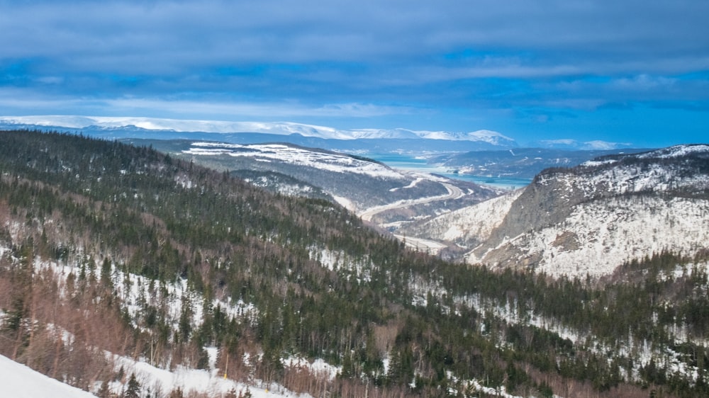 a man riding skis down the side of a snow covered slope