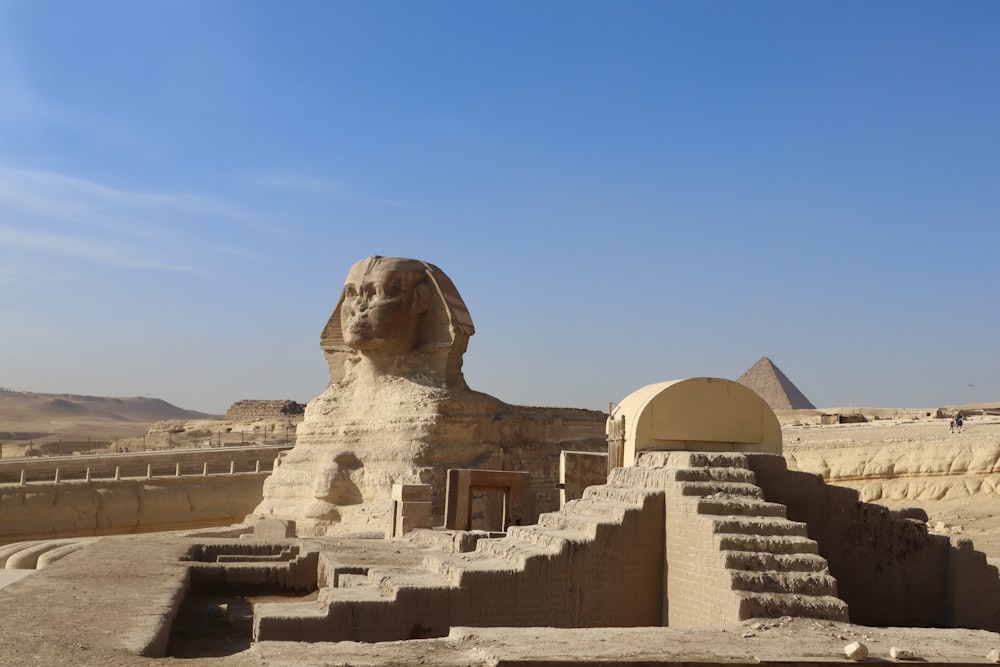 a large sphinx statue in the middle of a desert