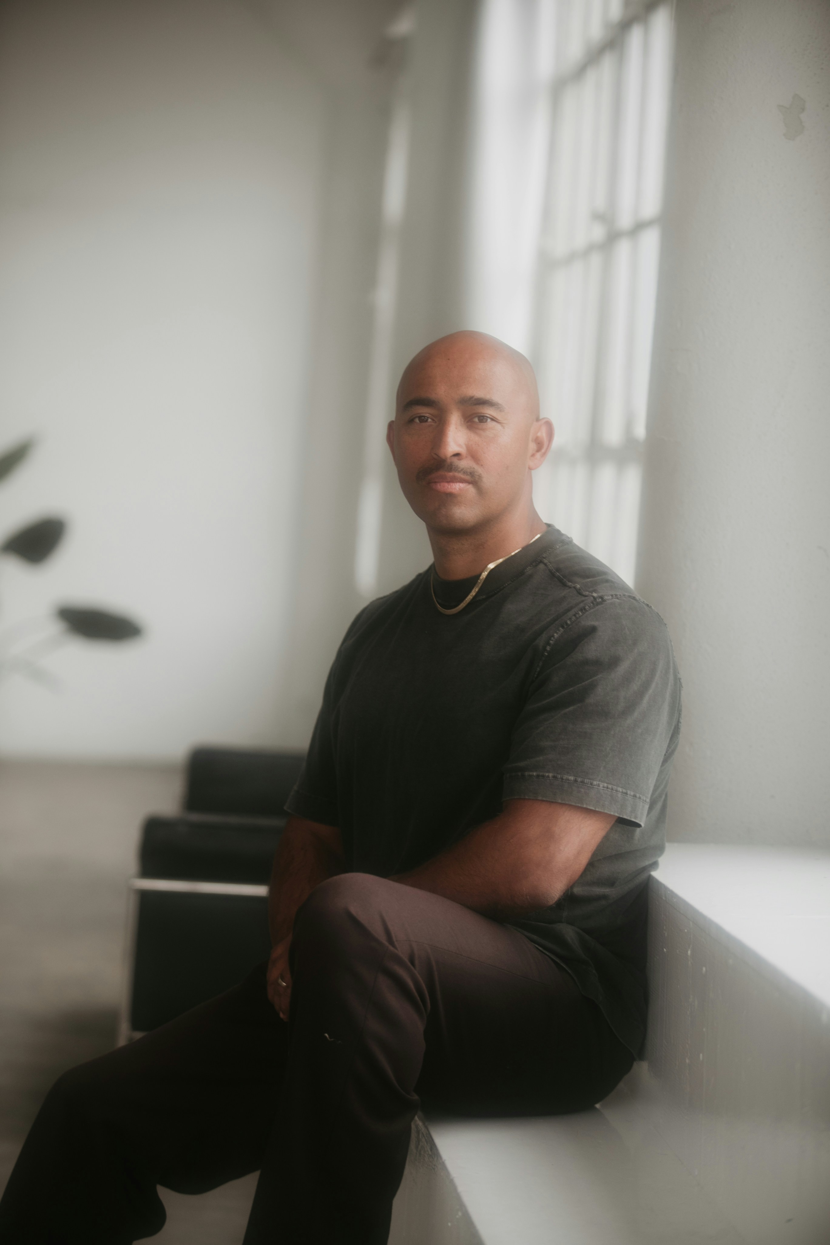 a man sitting on a bench in a room