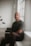 a man sitting on a bench in a room