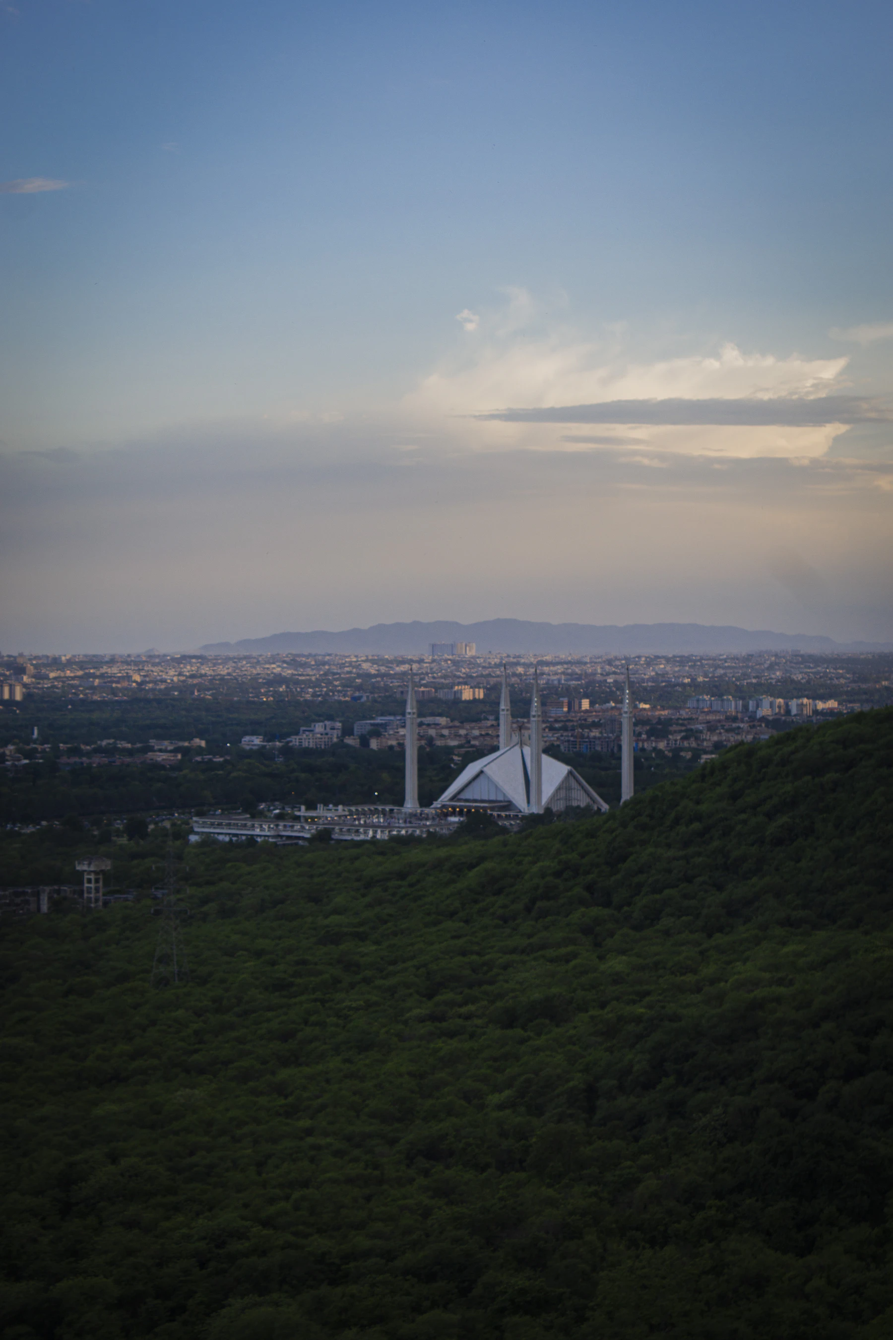Islamabad at dusk seen from the Margalla Hills, with the Faisal Mosque on the skyline