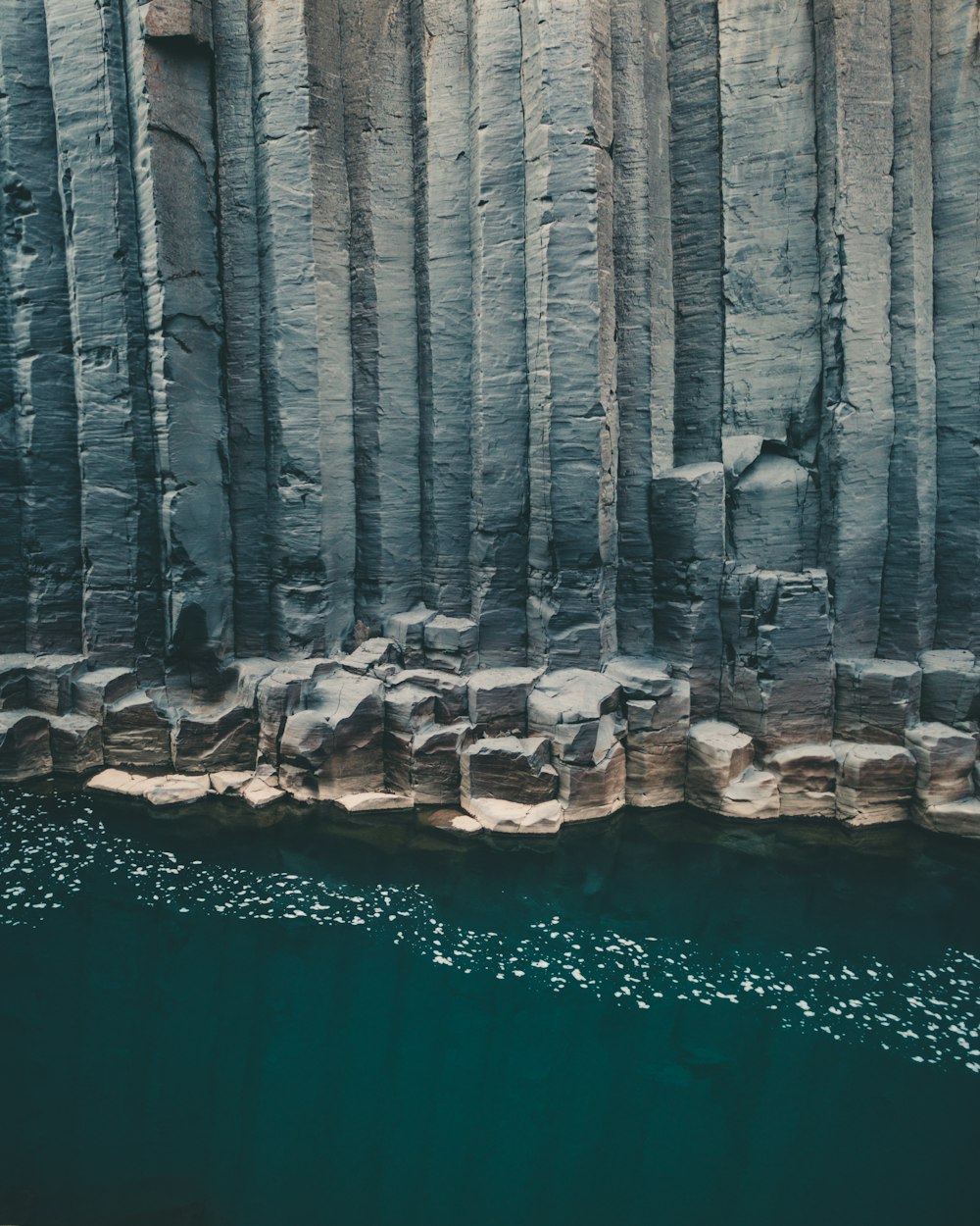 a body of water surrounded by large rocks