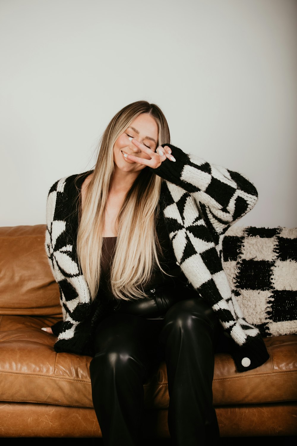 a woman sitting on a couch with her eyes closed