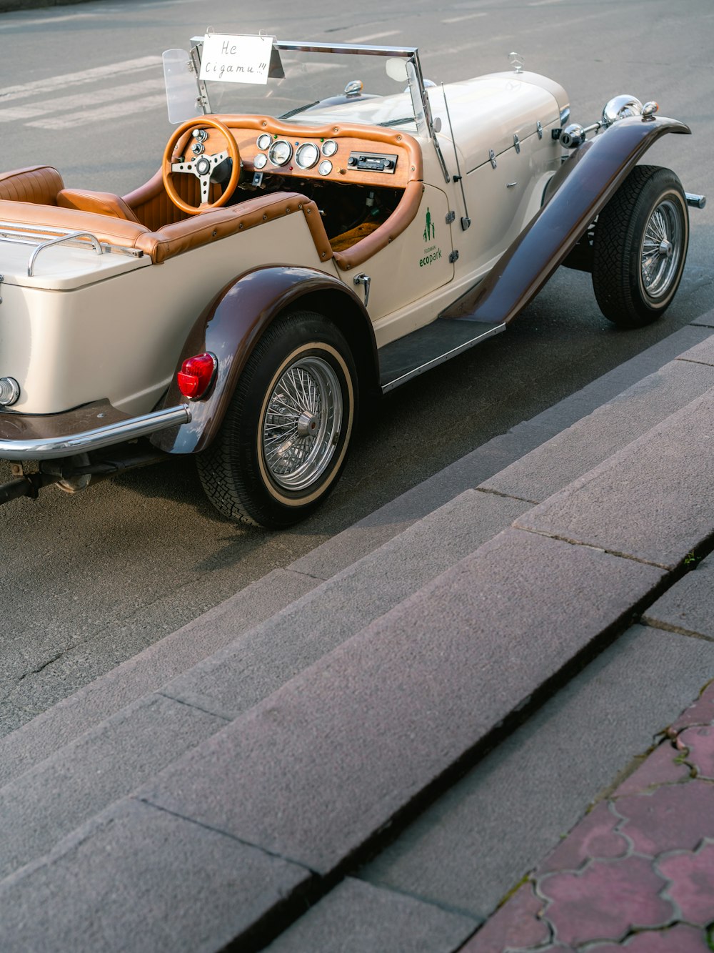 an old car is parked on the side of the road