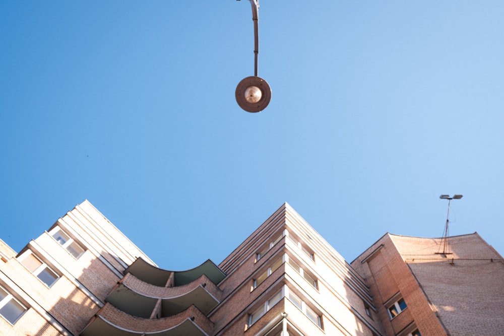 a street light hanging from the side of a tall building