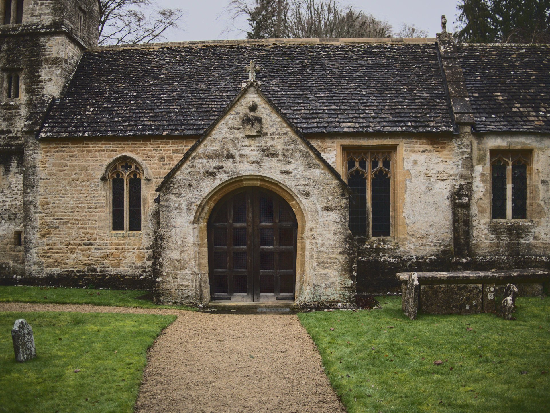 an old stone building with a stone pathway leading to it