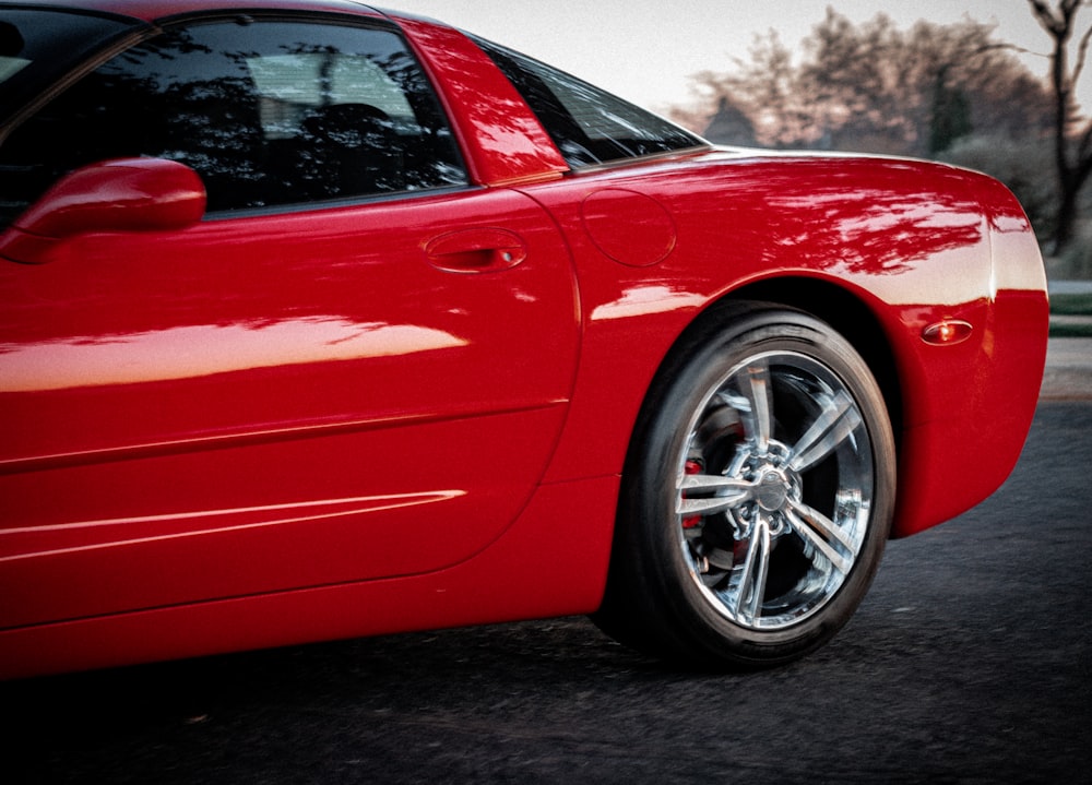 a red sports car parked on the side of the road