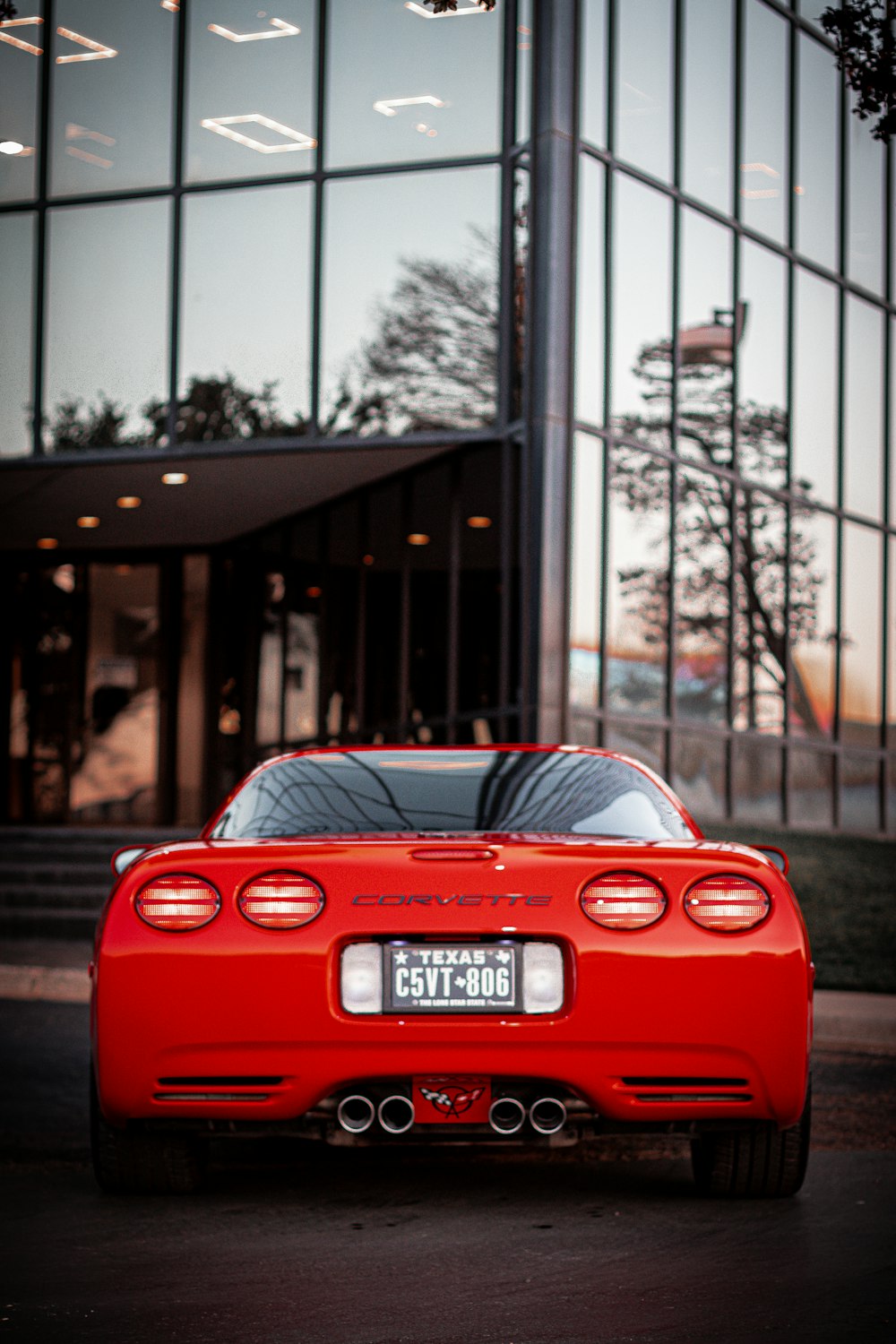 a red sports car parked in front of a building