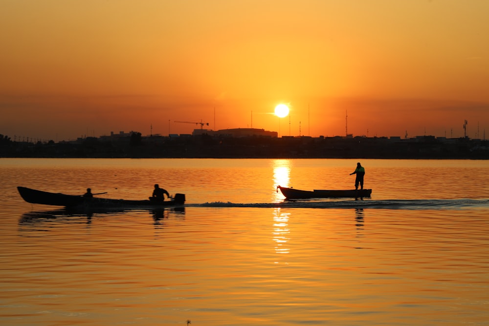 a couple of boats floating on top of a lake