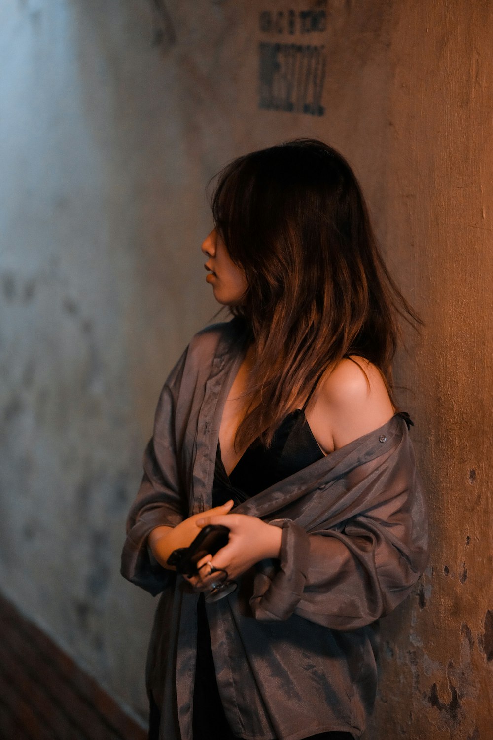 a woman standing in front of a wall