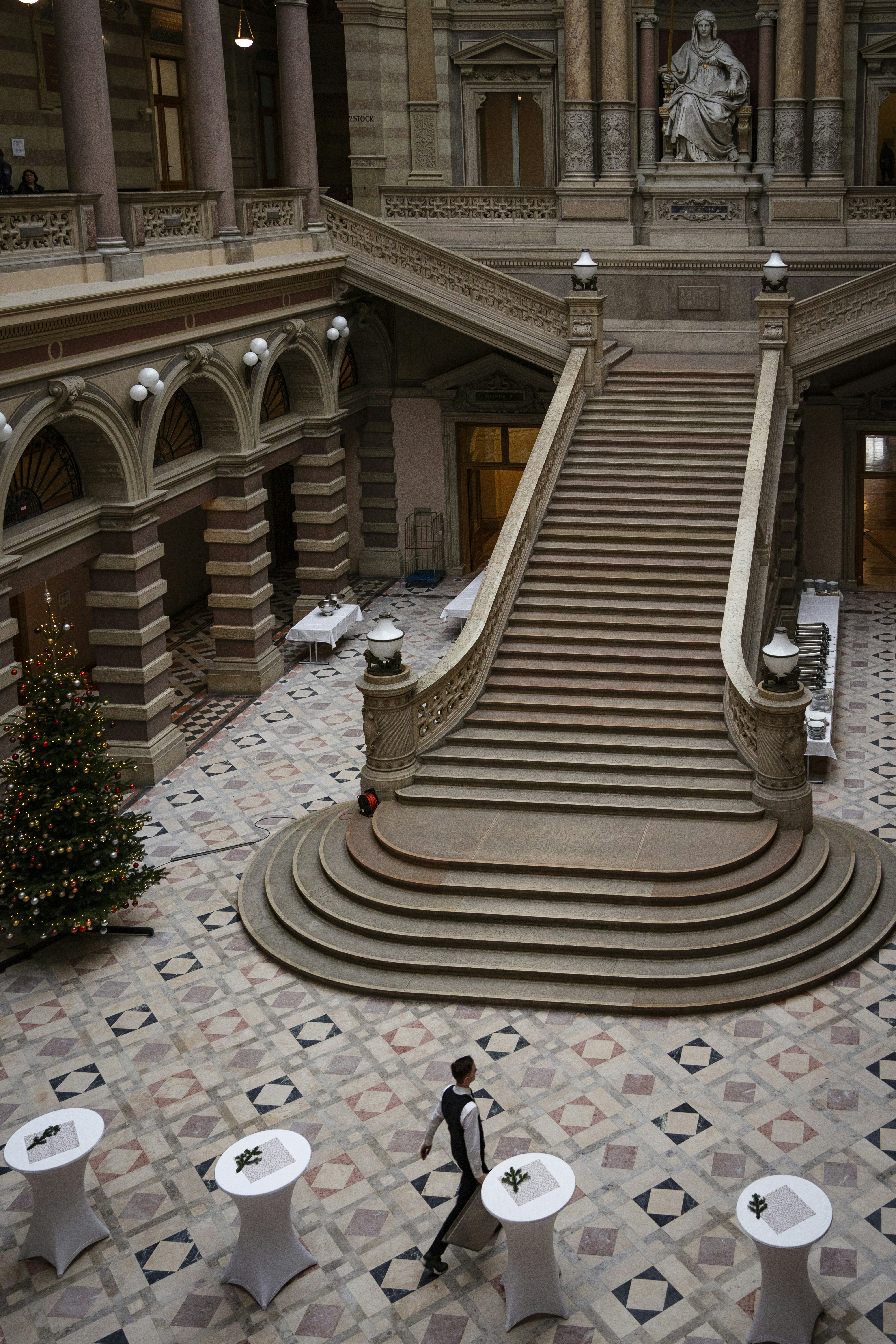a man is walking down the stairs of a building