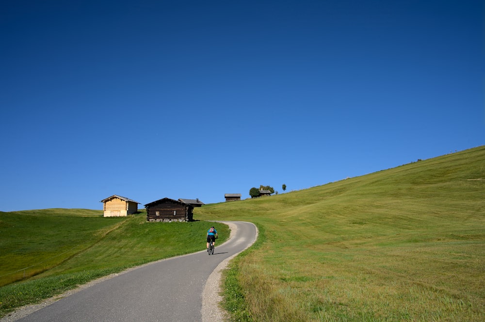 a man riding a bike down a curvy road