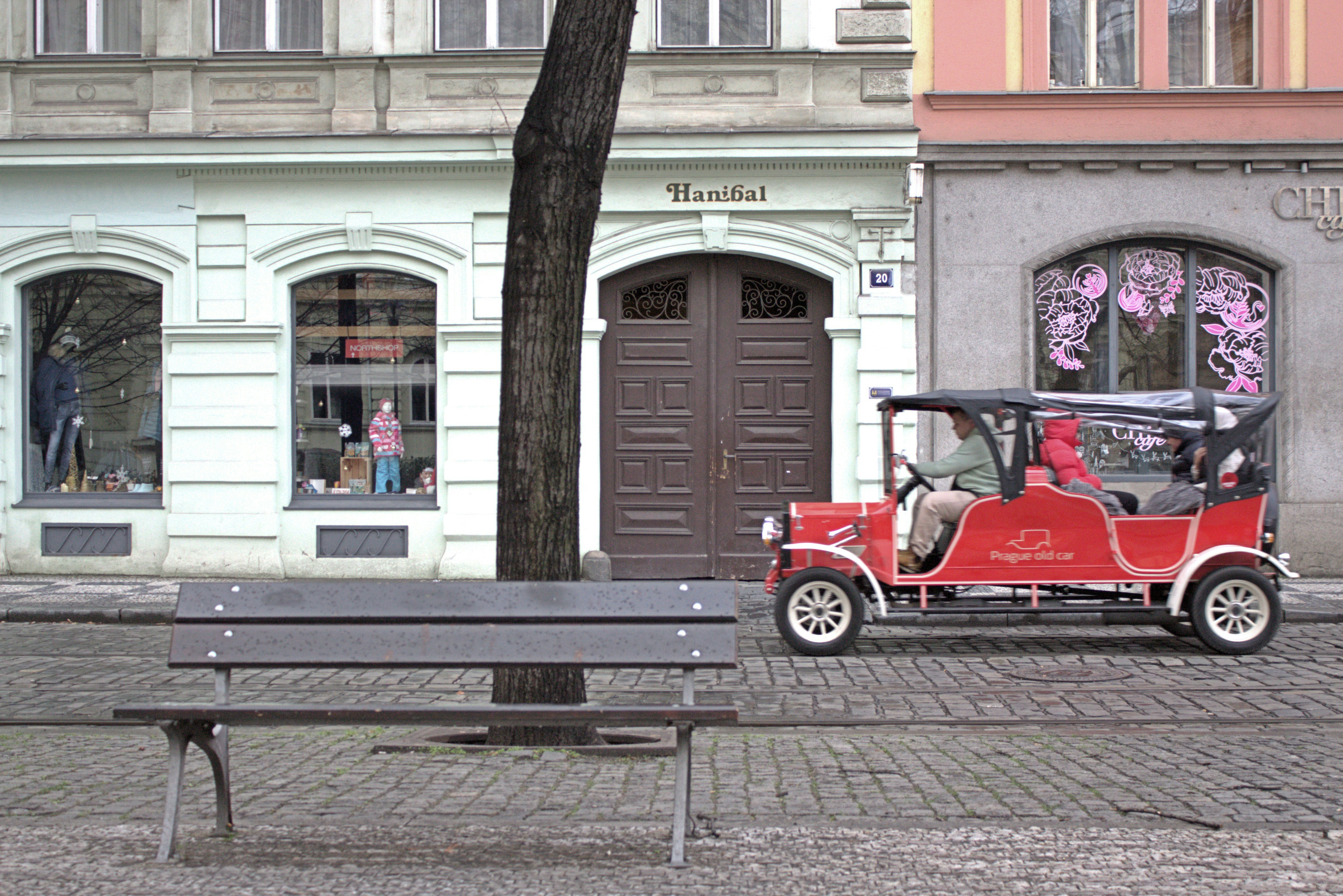 Small smart-style city car parked on a narrow urban street