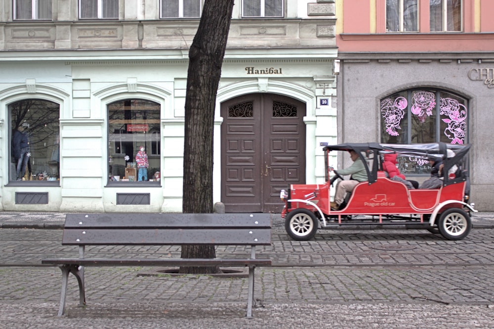 a red car parked in front of a building