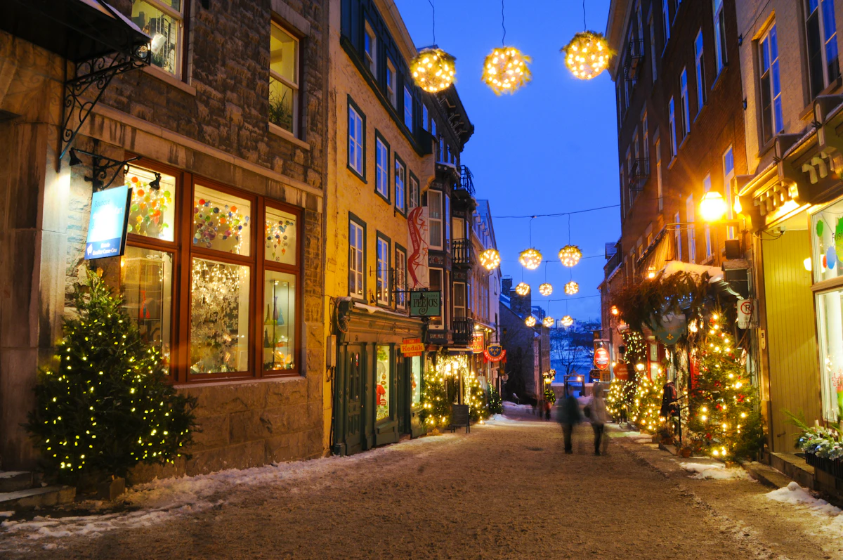 Evening street in Québec City lit by Christmas lights