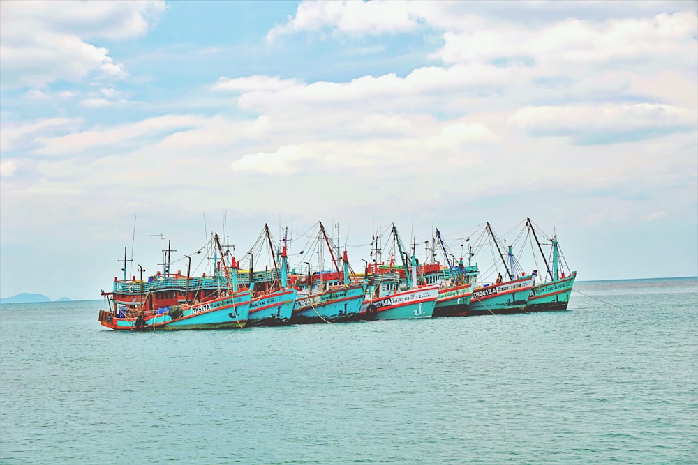 a group of boats floating on top of a large body of water