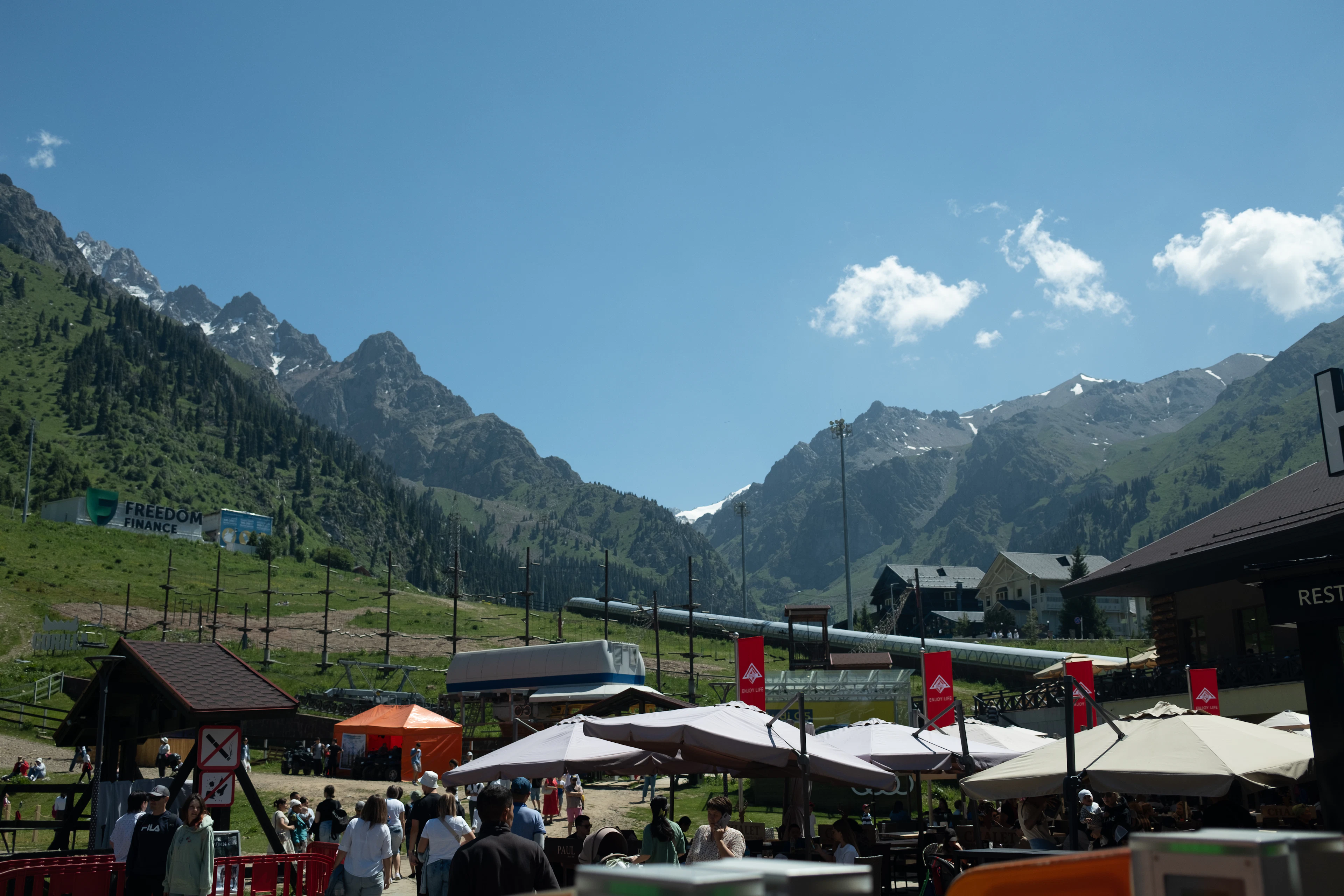 A mountain market at Almaty, stalls and umbrellas below the peaks of the Trans-Ili Alatau