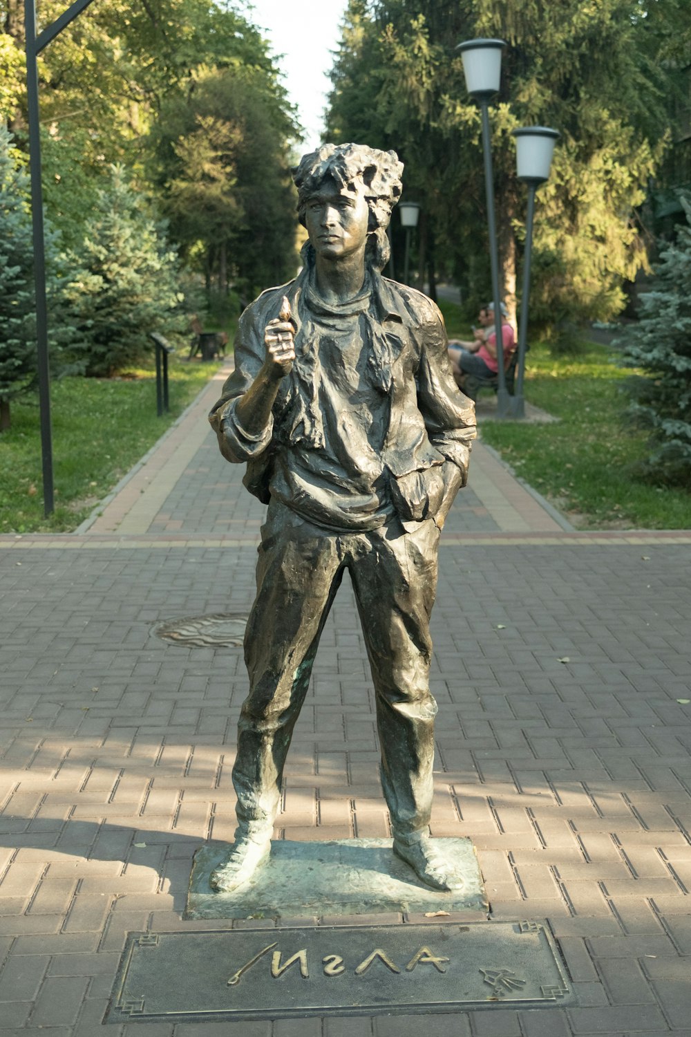 a bronze statue of a man holding a baseball bat