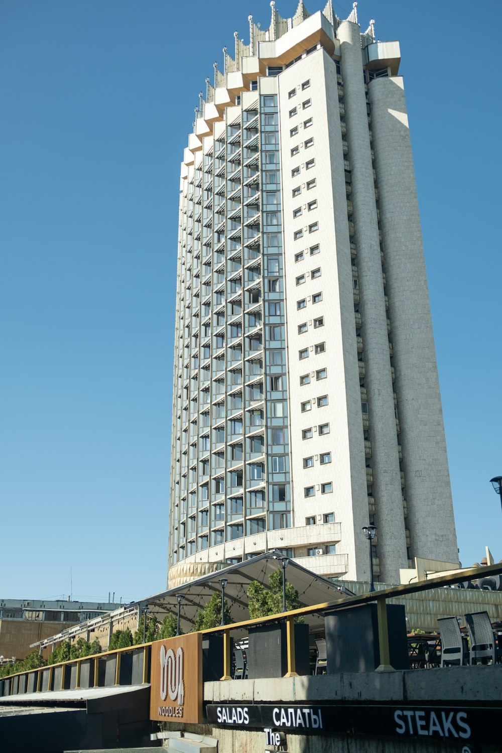 a tall white building with a sky background