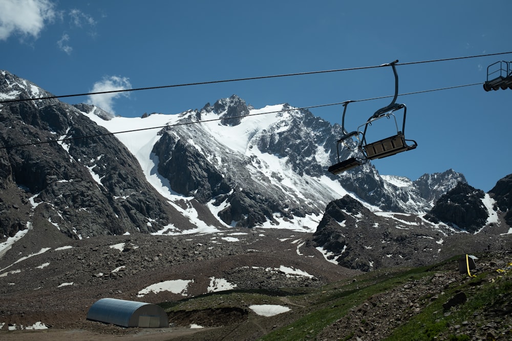 a ski lift going up a snowy mountain