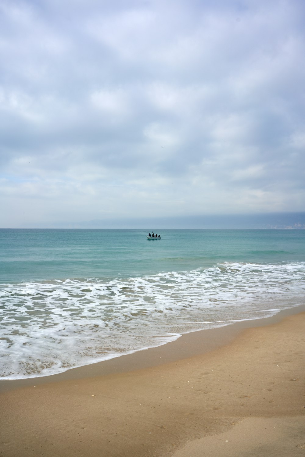 a couple of boats floating on top of a body of water