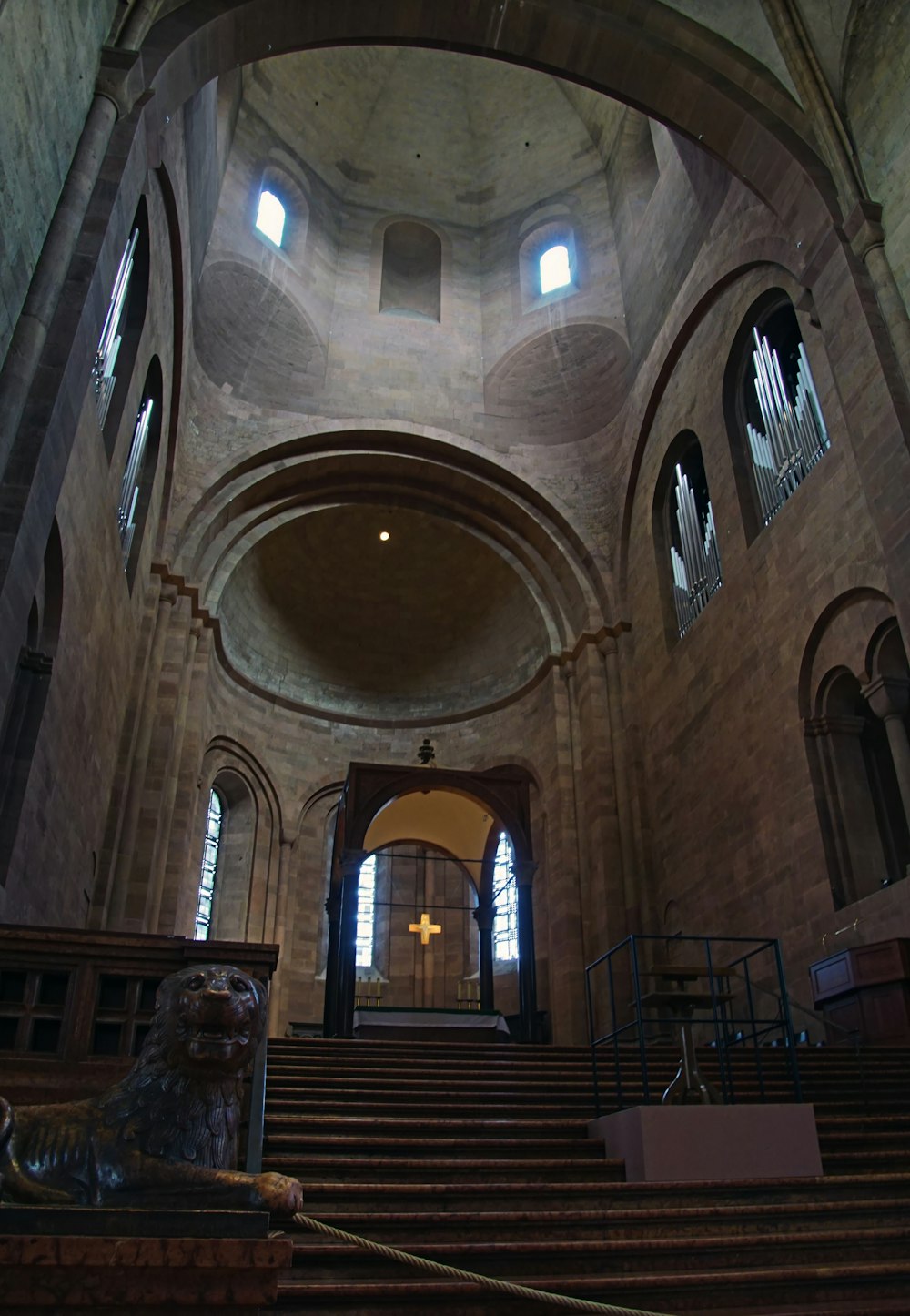 a church with a stone staircase and a statue of a lion