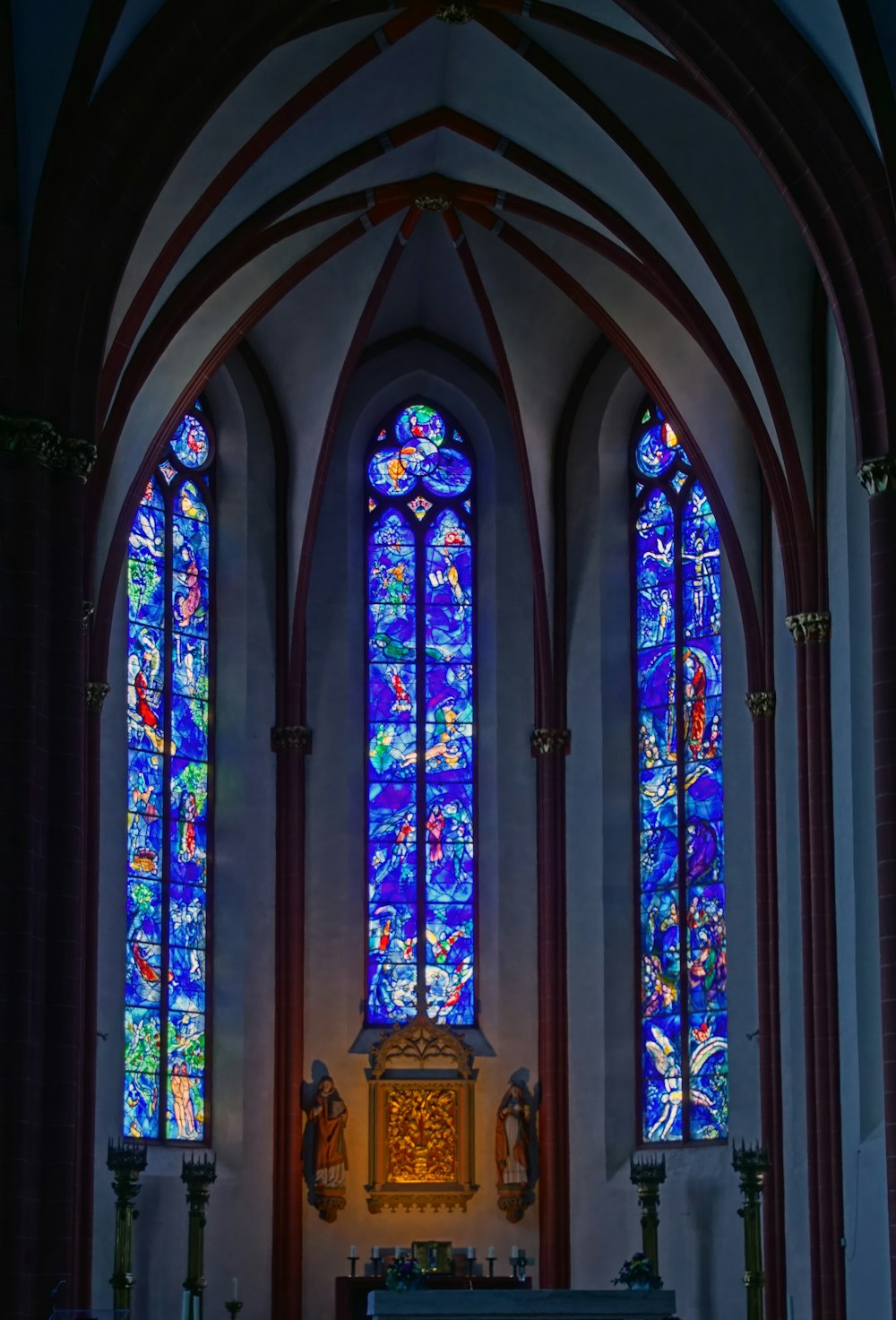 a church with stained glass windows and pews