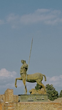 a statue of a man on a horse holding a flag