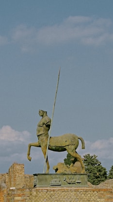 a statue of a man on a horse holding a flag