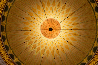 a ceiling in a building with a circular design
