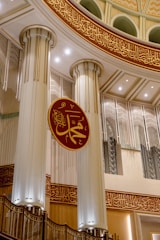 a building with columns and a sign in the middle of it