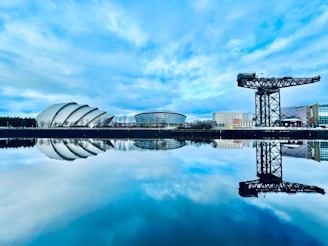 a large body of water with a building in the background