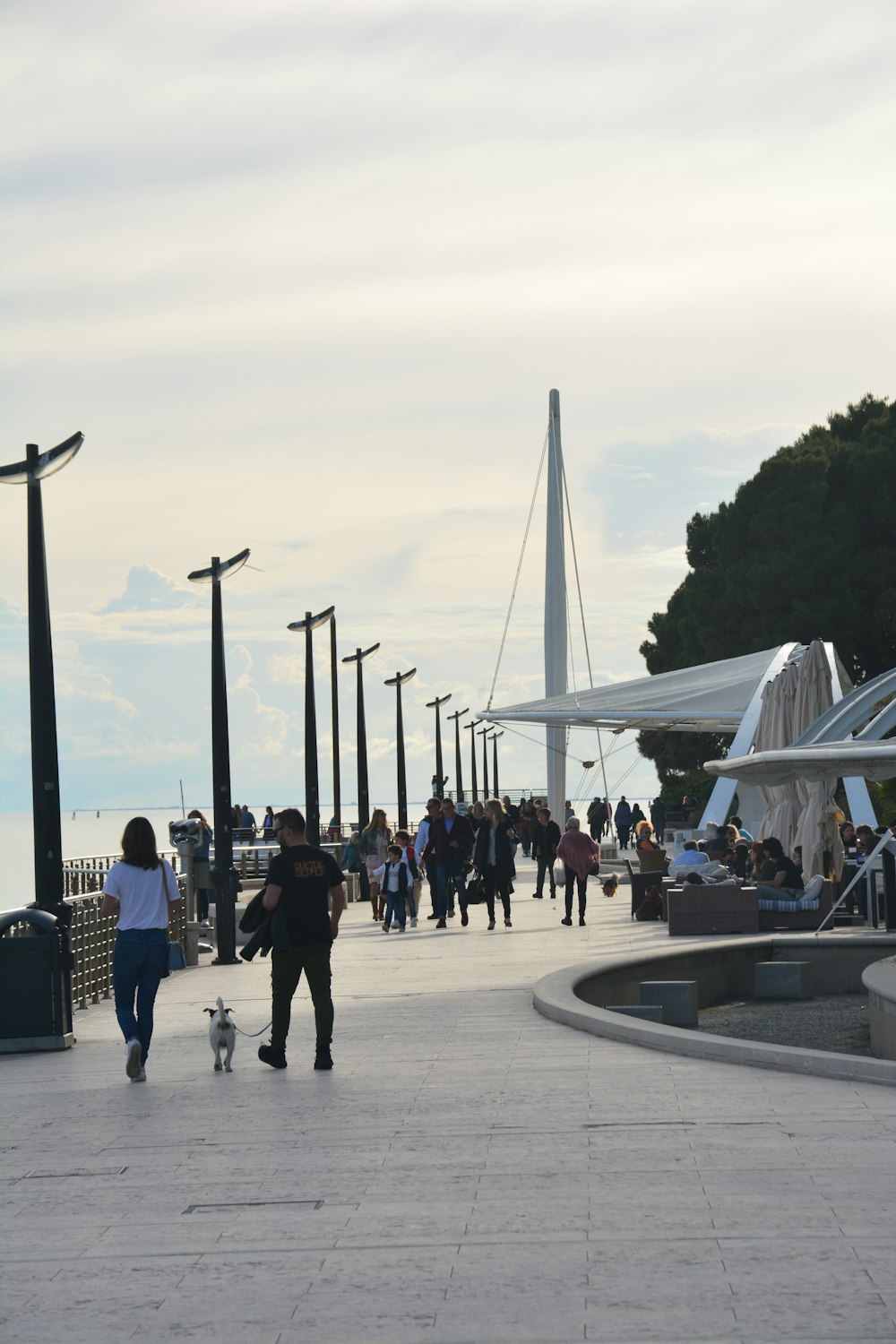 a group of people walking down a sidewalk