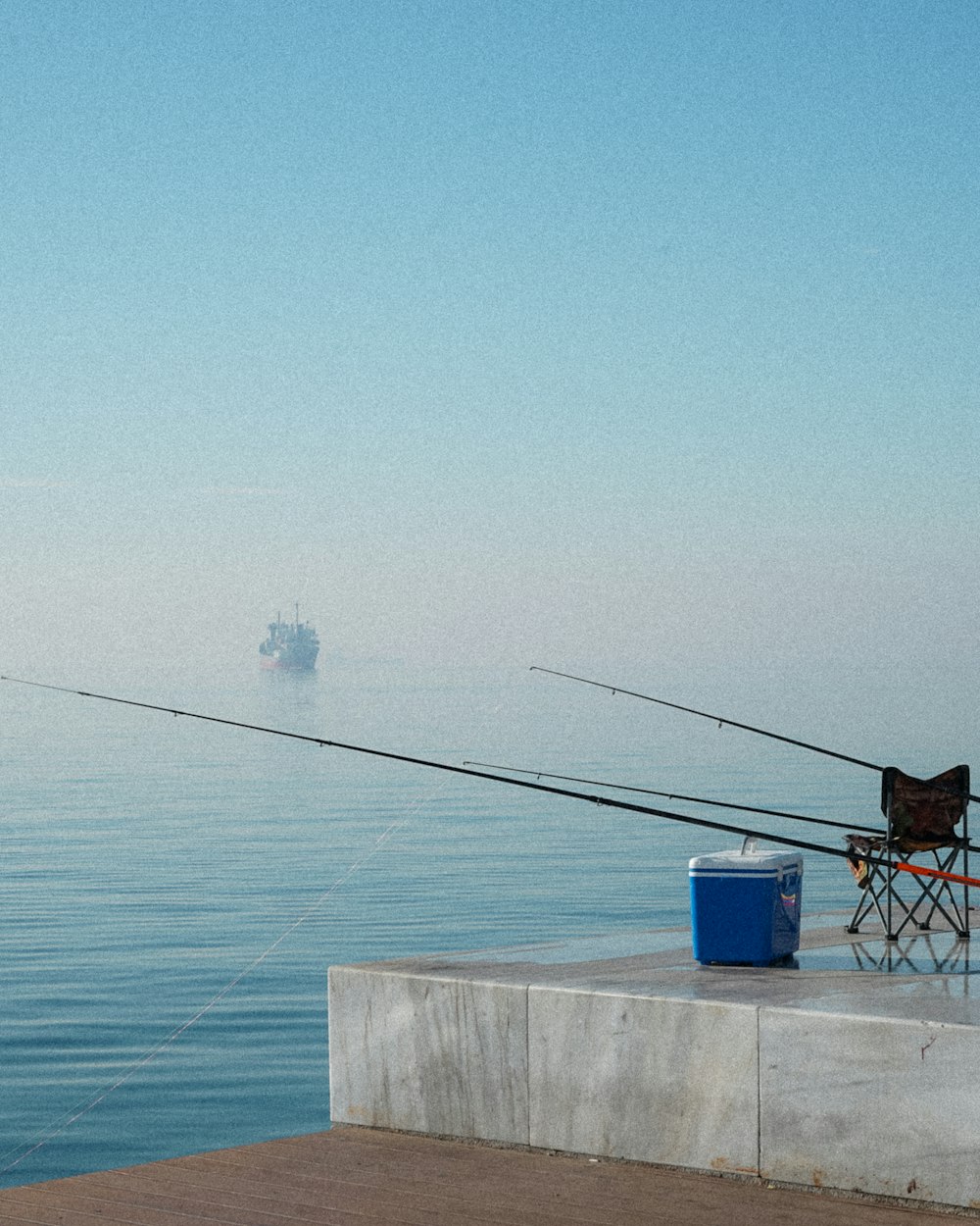 a fishing rod and a chair on a dock